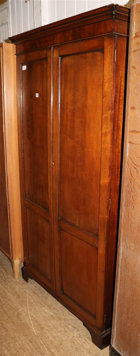 George III style mahogany two door panelled cupboard(-)